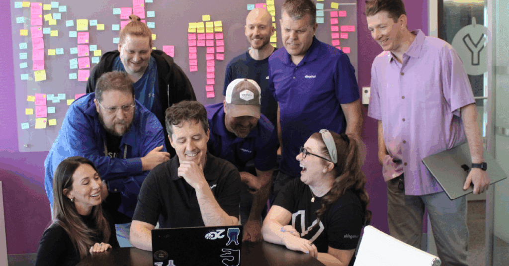 The Next 20 Years - David's Final Thoughts on 20 Moments/20 Years - David and team laughing around a computer screen